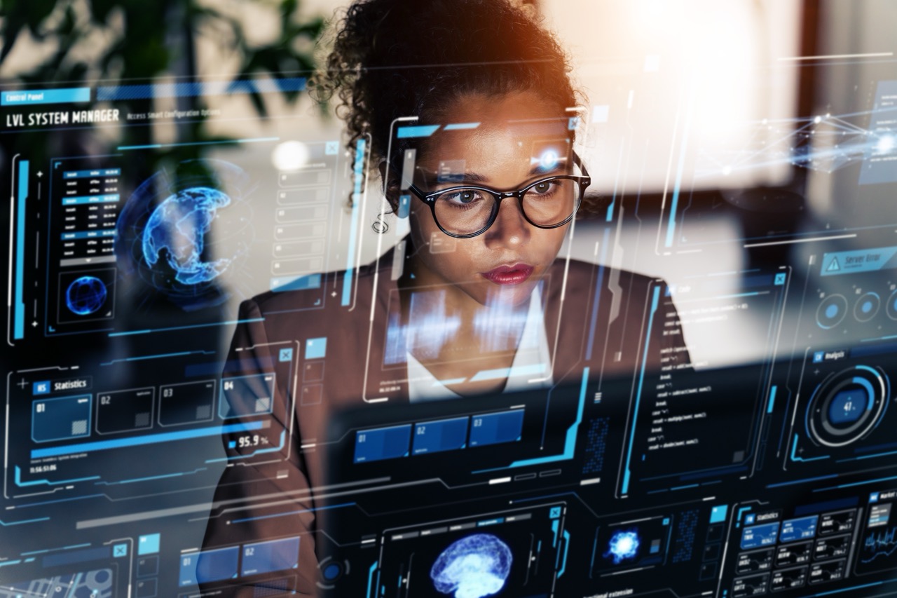 Woman wearing glasses in front of screen with analytics data displayed in air